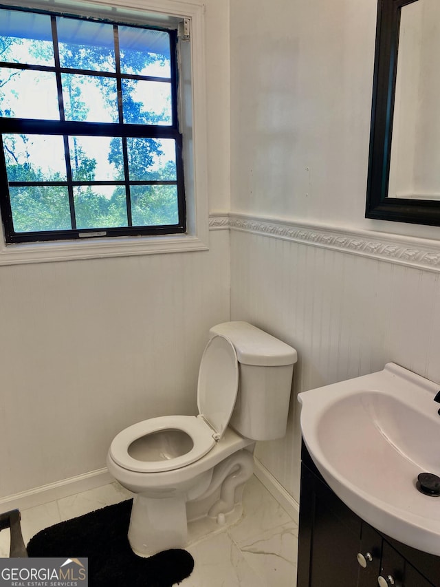 5 Red Fox Dr SW, Rome, GA 30165 - bathroom with toilet, vanity, wainscoting, marble look tiles, and baseboards