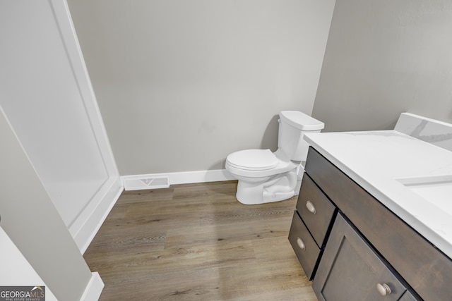 3689 Anderson Hwy, Hartwell, GA 30643 - half bath featuring wood finished floors, toilet, vanity, and baseboards