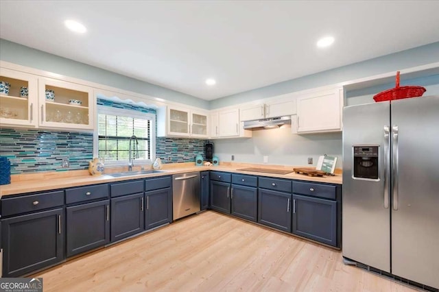 103 Ashley Marsh Dr, Brunswick, GA 31523 - kitchen with appliances with stainless steel finishes, a sink, white cabinetry, light wood-style flooring, and under cabinet range hood