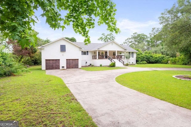 103 Ashley Marsh Dr, Brunswick, GA 31523 - view of front of house featuring a porch, concrete driveway, an attached garage, and a front yard