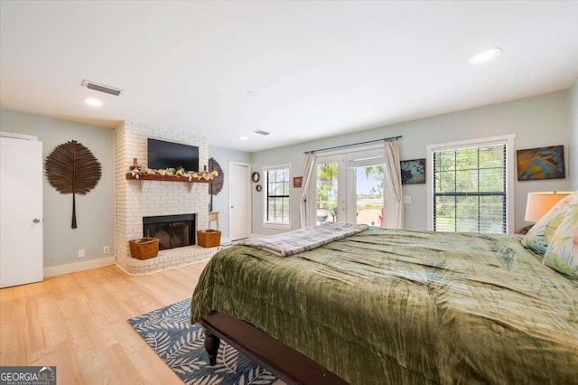 103 Ashley Marsh Dr, Brunswick, GA 31523 - bedroom featuring access to outside, wood finished floors, a fireplace, baseboards, and recessed lighting