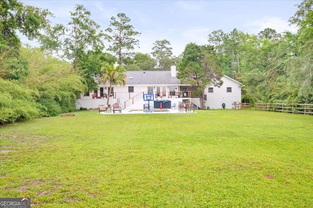 103 Ashley Marsh Dr, Brunswick, GA 31523 - rear view of house featuring a patio and a chimney