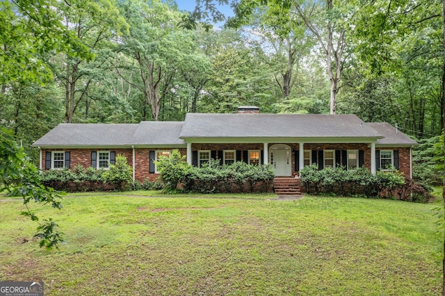 286 Hilton Way, Canton, GA 30114 - single story home with covered porch, brick siding, a front yard, and a chimney