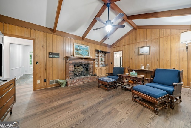 286 Hilton Way, Canton, GA 30114 - living room with a ceiling fan, wood walls, wood finished floors, and a fireplace