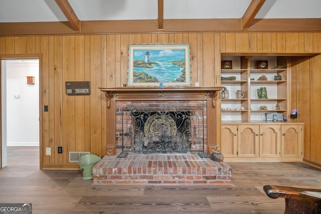 286 Hilton Way, Canton, GA 30114 - living area featuring beamed ceiling, wood finished floors, wood walls, and a brick fireplace