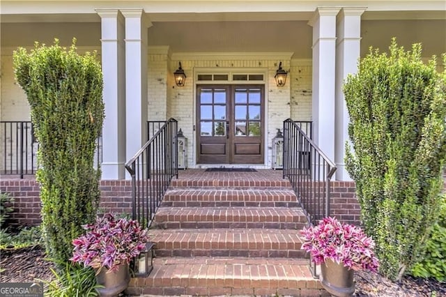 126 Townsend Pass, Alpharetta, GA 30004 - doorway to property featuring brick siding, covered porch, and french doors