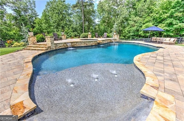 126 Townsend Pass, Alpharetta, GA 30004 - view of pool featuring a patio, view of wooded area, and a pool with connected hot tub