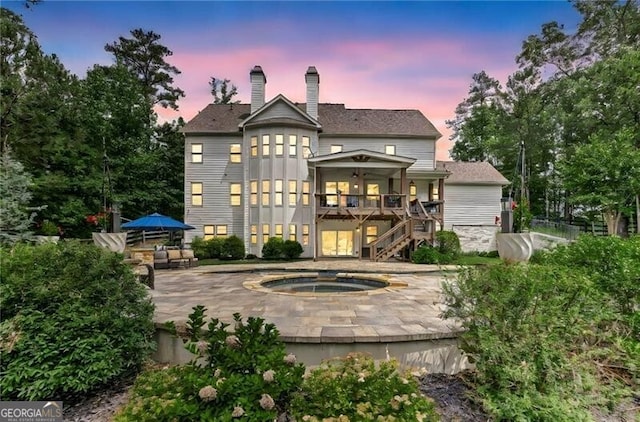 126 Townsend Pass, Alpharetta, GA 30004 - rear view of house featuring an in-ground hot tub, a patio, a chimney, stairway, and a wooden deck