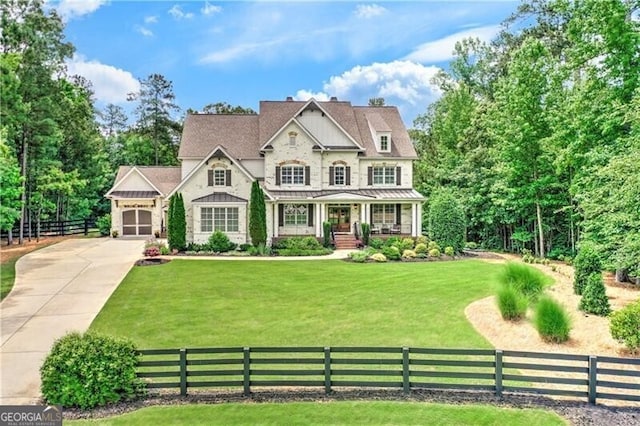 126 Townsend Pass, Alpharetta, GA 30004 - view of front of house with a standing seam roof, covered porch, concrete driveway, and a metal roof