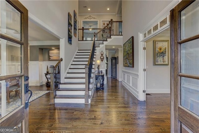 126 Townsend Pass, Alpharetta, GA 30004 - foyer entrance with crown molding, a towering ceiling, a decorative wall, stairs, and wood finished floors