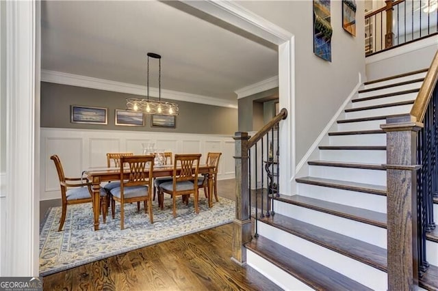 126 Townsend Pass, Alpharetta, GA 30004 - dining area with ornamental molding, a decorative wall, stairs, dark wood-style floors, and a wainscoted wall