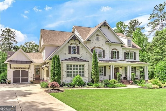 126 Townsend Pass, Alpharetta, GA 30004 - view of front of property with a porch, driveway, a garage, a front yard, and board and batten siding