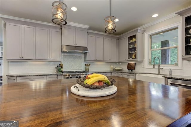 126 Townsend Pass, Alpharetta, GA 30004 - kitchen with under cabinet range hood, crown molding, hanging light fixtures, recessed lighting, and butcher block countertops