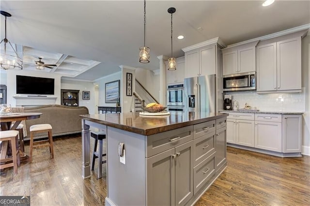 126 Townsend Pass, Alpharetta, GA 30004 - kitchen featuring appliances with stainless steel finishes, ceiling fan, dark wood-style floors, recessed lighting, and a kitchen breakfast bar