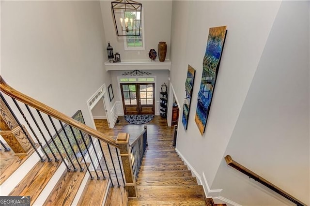 126 Townsend Pass, Alpharetta, GA 30004 - staircase with a towering ceiling, wood finished floors, french doors, and a chandelier