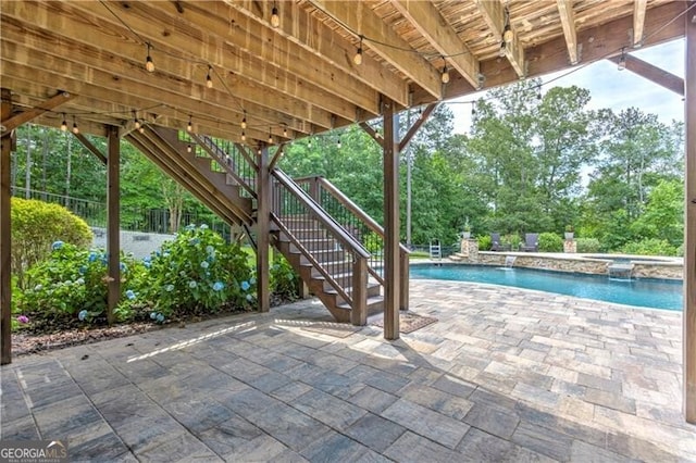 126 Townsend Pass, Alpharetta, GA 30004 - view of patio with stairs, a pool with connected hot tub, and view of wooded area