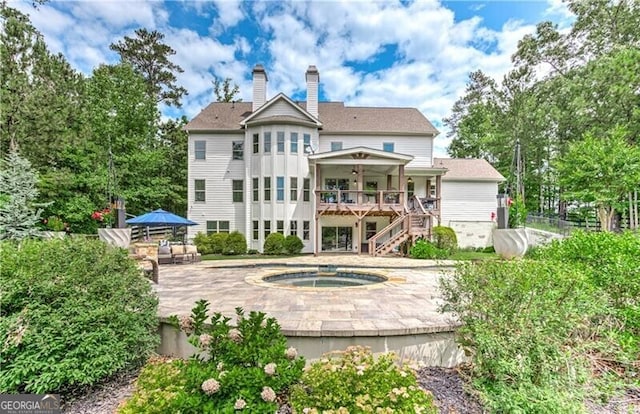 126 Townsend Pass, Alpharetta, GA 30004 - rear view of house featuring an in-ground hot tub, stairs, a chimney, a wooden deck, and a patio