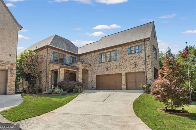 3834 Chamblee Dunwoody Rd, Atlanta, GA 30341 - view of front of property with driveway, a front lawn, brick siding, and an attached garage