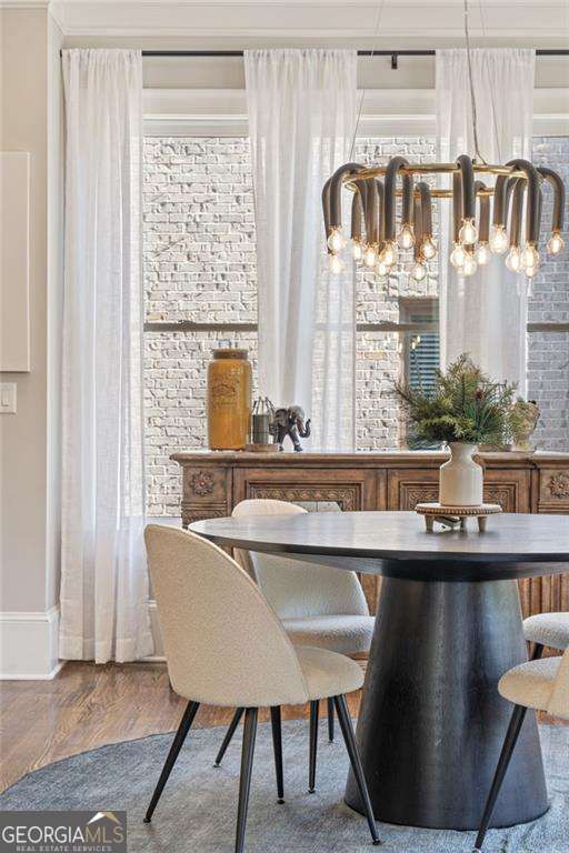3834 Chamblee Dunwoody Rd, Atlanta, GA 30341 - bar area featuring a chandelier, wood finished floors, and brick wall