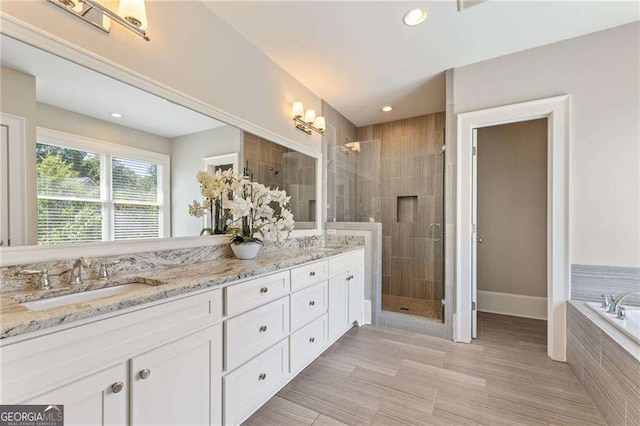 3834 Chamblee Dunwoody Rd, Atlanta, GA 30341 - bathroom with a stall shower, double vanity, a garden tub, recessed lighting, and tile patterned flooring