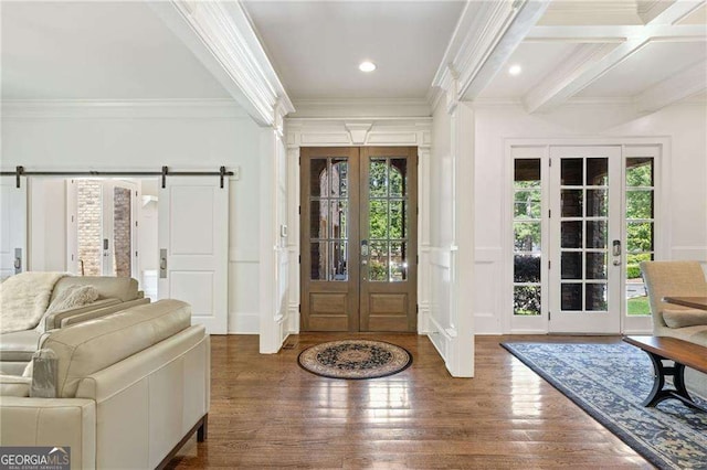 3834 Chamblee Dunwoody Rd, Atlanta, GA 30341 - foyer entrance featuring a decorative wall, crown molding, french doors, a barn door, and wood finished floors