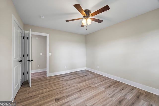 1180 Treadwell Bridge Rd, Statham, GA 30666 - empty room with a ceiling fan, light wood finished floors, and a smoke detector