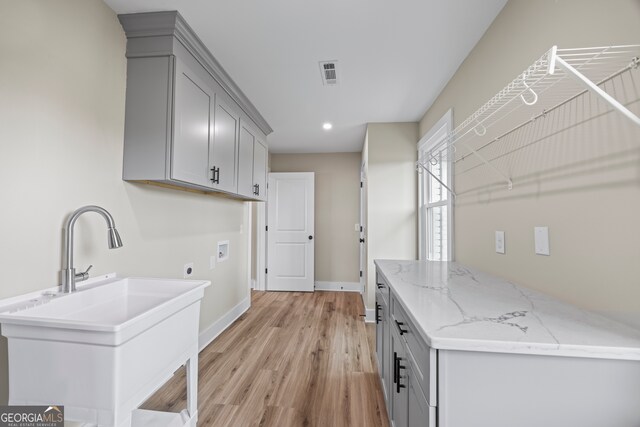 1180 Treadwell Bridge Rd, Statham, GA 30666 - laundry area featuring hookup for a washing machine, hookup for an electric dryer, light wood-style floors, baseboards, and recessed lighting