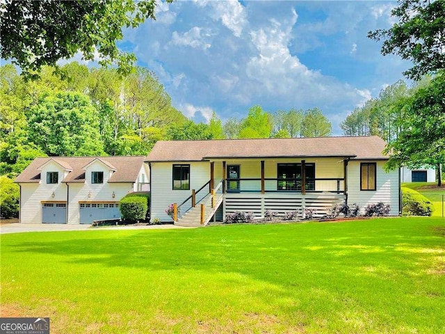 345 Etheridge Rd, Auburn, GA 30011 - view of front of home featuring covered porch, a front yard, and a detached garage
