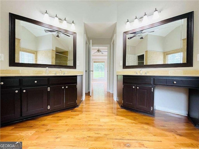 345 Etheridge Rd, Auburn, GA 30011 - bathroom with ceiling fan, two vanities, and wood finished floors