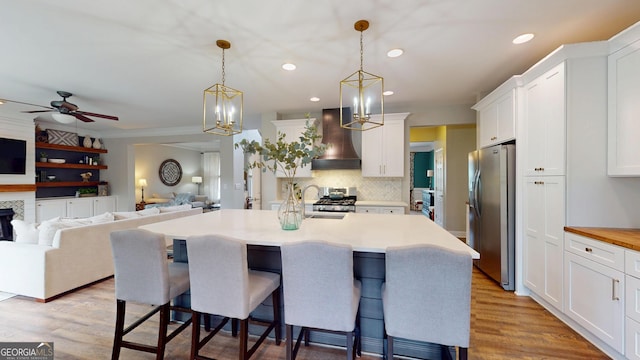 1346 Wind Chime Ct, Lawrenceville, GA 30045 - kitchen with stainless steel fridge, custom exhaust hood, a breakfast bar area, white cabinets, and light countertops