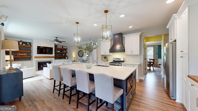 1346 Wind Chime Ct, Lawrenceville, GA 30045 - kitchen with premium range hood, stainless steel appliances, a sink, ceiling fan, and white cabinetry