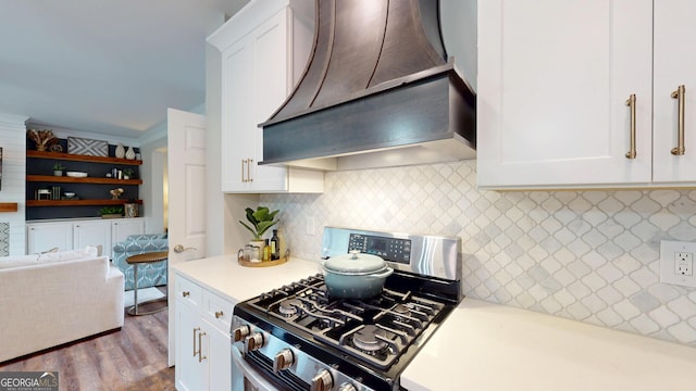 1346 Wind Chime Ct, Lawrenceville, GA 30045 - kitchen featuring stainless steel range with gas stovetop, custom range hood, light countertops, white cabinetry, and wood finished floors