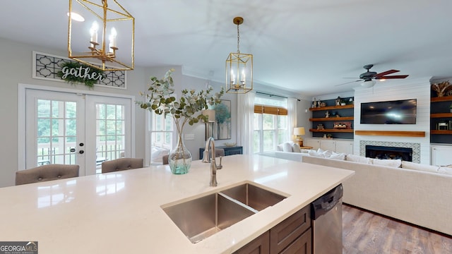 1346 Wind Chime Ct, Lawrenceville, GA 30045 - kitchen featuring a sink, dishwasher, pendant lighting, a chandelier, and wood finished floors