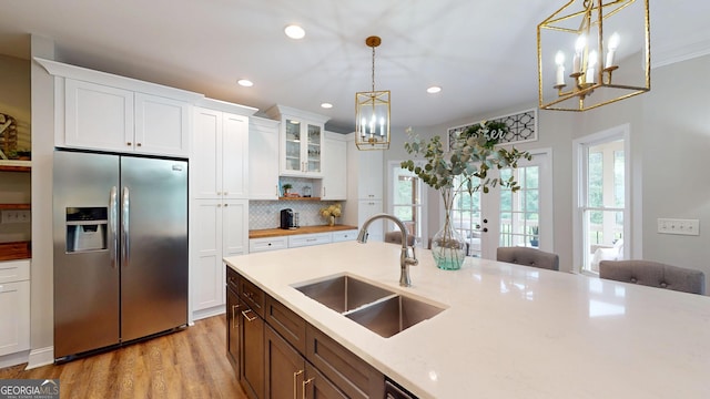 1346 Wind Chime Ct, Lawrenceville, GA 30045 - kitchen with stainless steel fridge with ice dispenser, a sink, a chandelier, decorative light fixtures, and tasteful backsplash