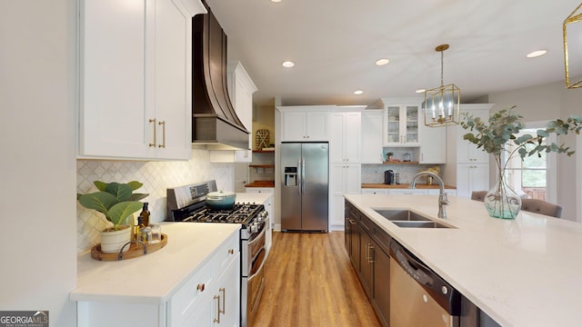 1346 Wind Chime Ct, Lawrenceville, GA 30045 - kitchen featuring stainless steel appliances, a sink, custom exhaust hood, decorative backsplash, and light countertops