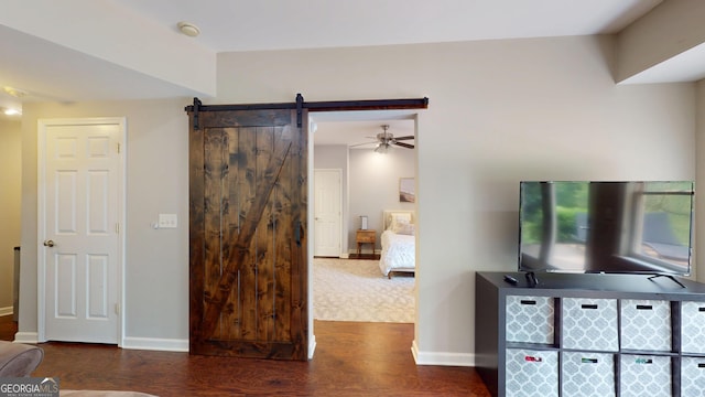 1346 Wind Chime Ct, Lawrenceville, GA 30045 - living area with wood finished floors, baseboards, a ceiling fan, and a barn door