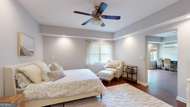 1346 Wind Chime Ct, Lawrenceville, GA 30045 - bedroom featuring dark wood finished floors, a wall unit AC, a ceiling fan, baseboards, and recessed lighting
