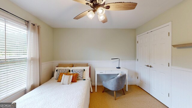 1346 Wind Chime Ct, Lawrenceville, GA 30045 - carpeted bedroom featuring wainscoting, a closet, and ceiling fan