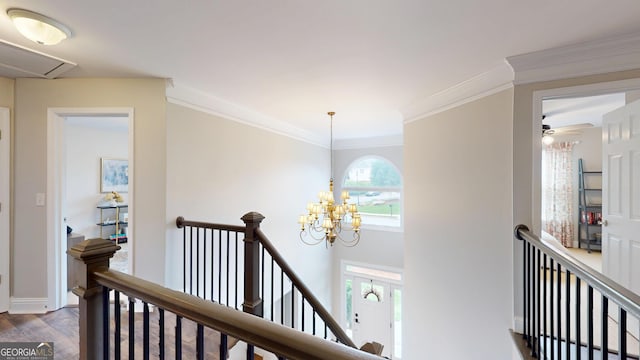 1346 Wind Chime Ct, Lawrenceville, GA 30045 - hall featuring an upstairs landing, a chandelier, wood finished floors, baseboards, and ornamental molding