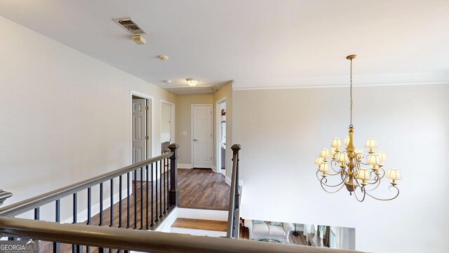 1346 Wind Chime Ct, Lawrenceville, GA 30045 - hallway with an upstairs landing, a chandelier, wood finished floors, crown molding, and baseboards