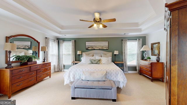 1346 Wind Chime Ct, Lawrenceville, GA 30045 - bedroom featuring a raised ceiling, light colored carpet, crown molding, and a ceiling fan