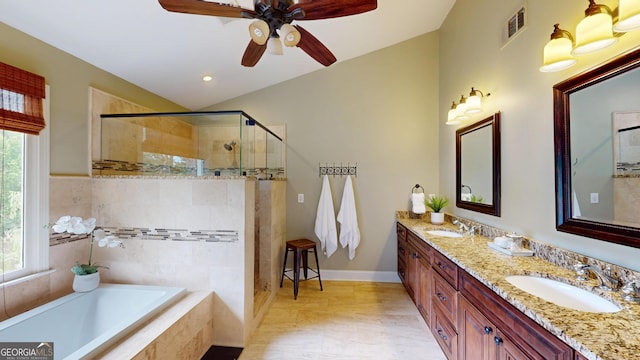 1346 Wind Chime Ct, Lawrenceville, GA 30045 - bathroom featuring double vanity, a shower stall, a garden tub, ceiling fan, and baseboards