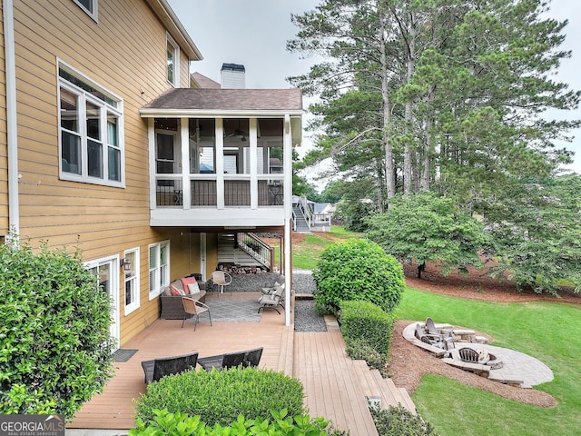 1346 Wind Chime Ct, Lawrenceville, GA 30045 - deck featuring an outdoor fire pit, a sunroom, stairs, and a yard