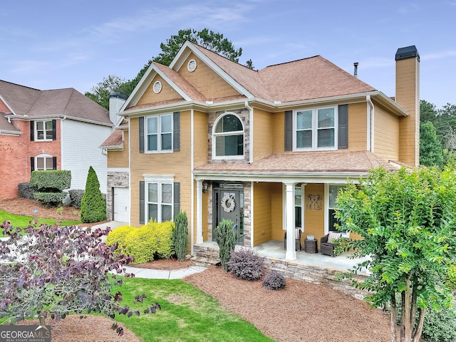 1346 Wind Chime Ct, Lawrenceville, GA 30045 - view of front facade with a chimney and a porch