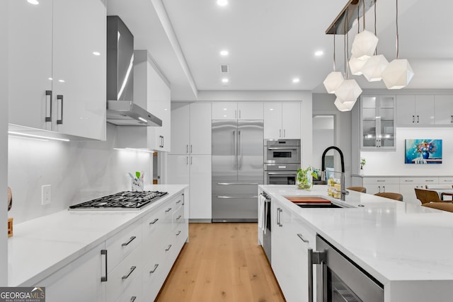 2425 Peachtree Rd NE Unit 902, Atlanta, GA 30305 - kitchen with appliances with stainless steel finishes, wall chimney range hood, modern cabinets, wine cooler, and white cabinets