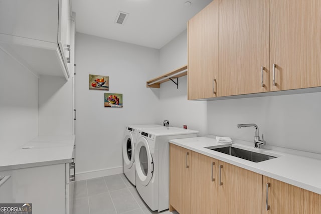 2425 Peachtree Rd NE Unit 902, Atlanta, GA 30305 - washroom with cabinet space, separate washer and dryer, and light tile patterned floors