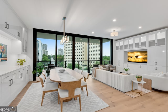 2425 Peachtree Rd NE Unit 902, Atlanta, GA 30305 - dining space featuring a wall of windows, light wood-type flooring, and a chandelier