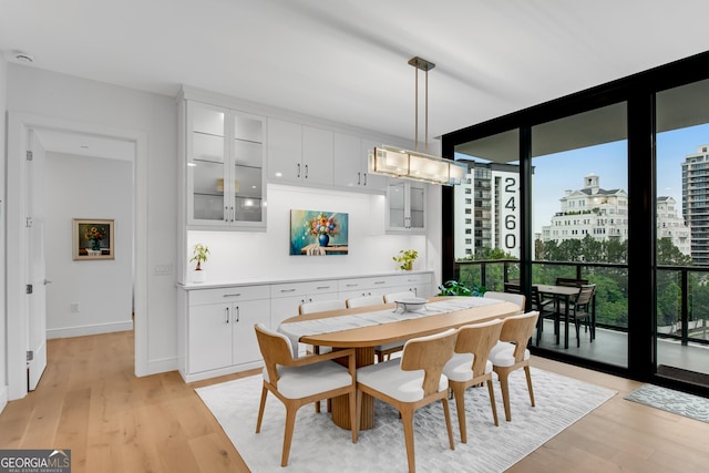 2425 Peachtree Rd NE Unit 902, Atlanta, GA 30305 - dining space featuring expansive windows, light wood-style flooring, and a view of city