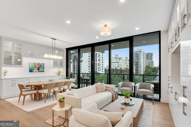 2425 Peachtree Rd NE Unit 902, Atlanta, GA 30305 - living area featuring plenty of natural light, light wood-style floors, floor to ceiling windows, recessed lighting, and a city view