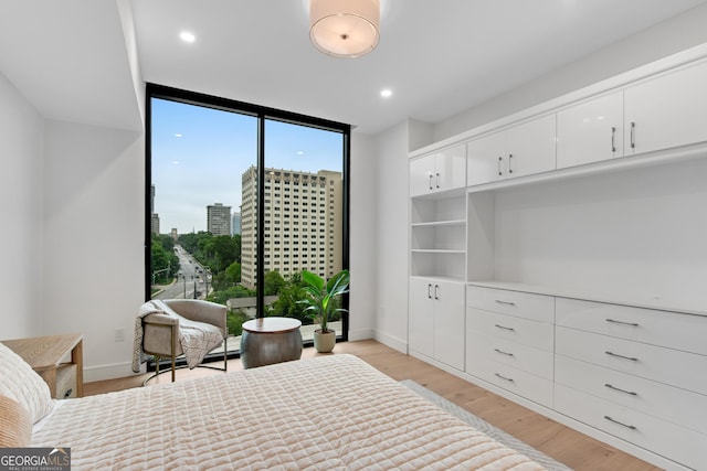 2425 Peachtree Rd NE Unit 902, Atlanta, GA 30305 - bedroom with floor to ceiling windows, light wood-style flooring, and recessed lighting